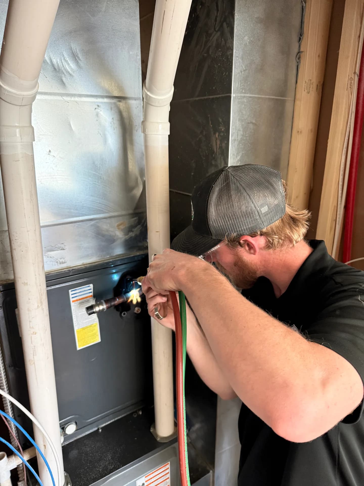 An All Around technician brazing a line during a furnace repair