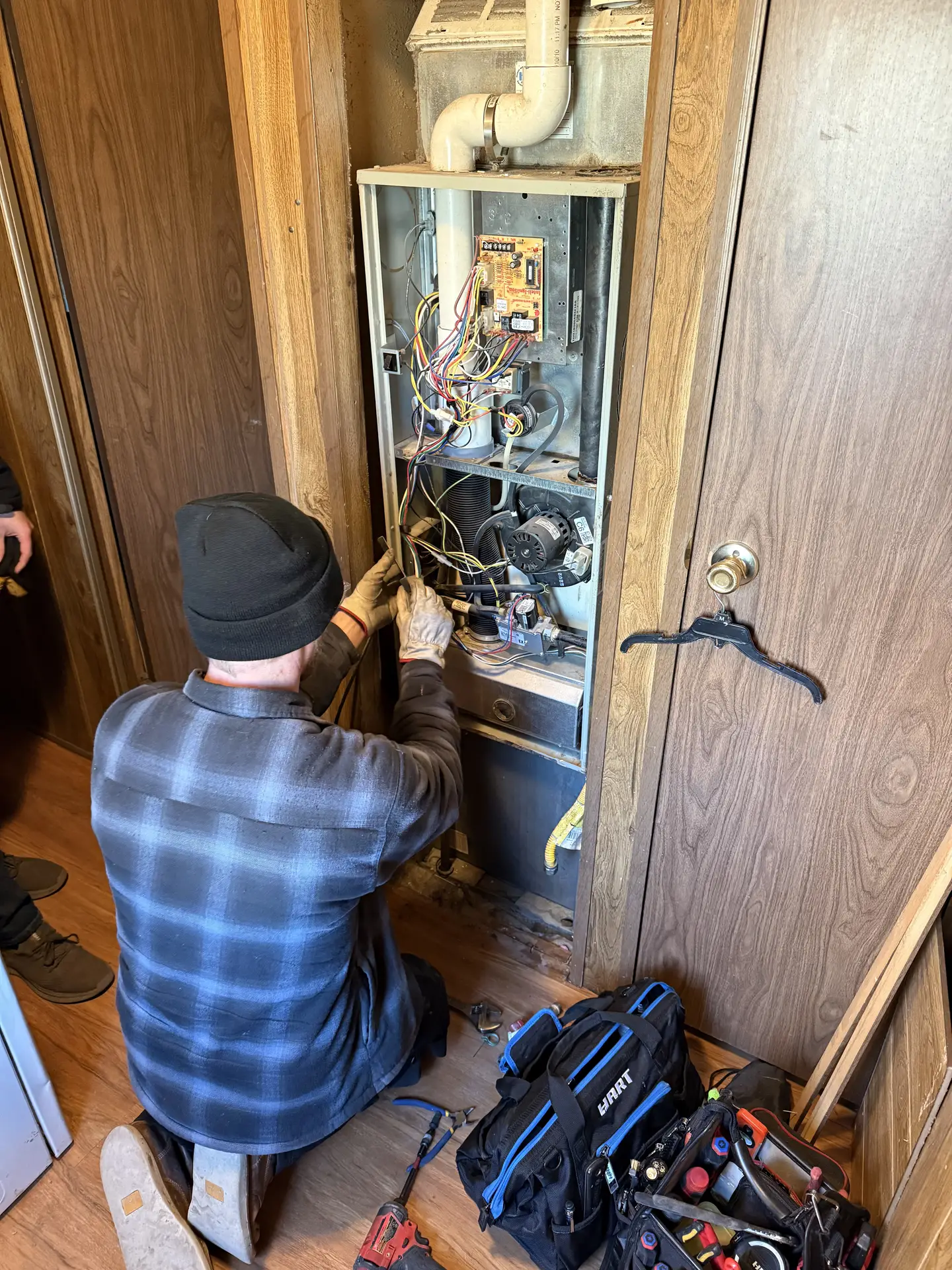 Rewiring a furnace during a repair visit in West Jordan