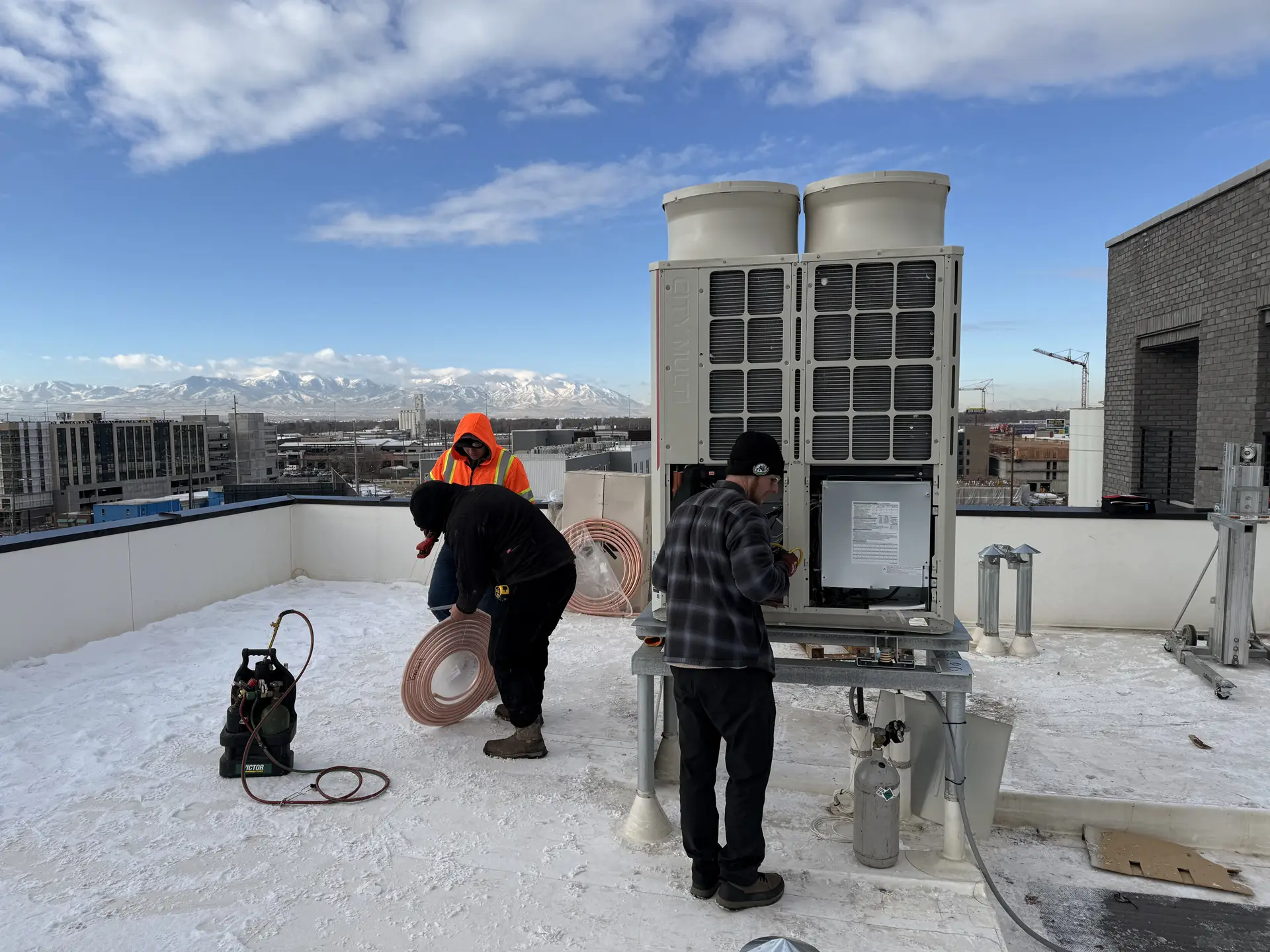 The crew setting a rooftop system above the Salt Lake valley