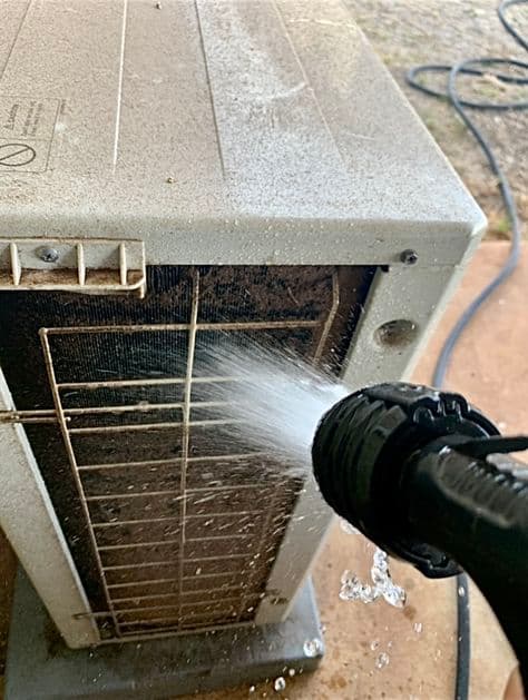 Power washing air conditioning condenser coils to improve efficiency