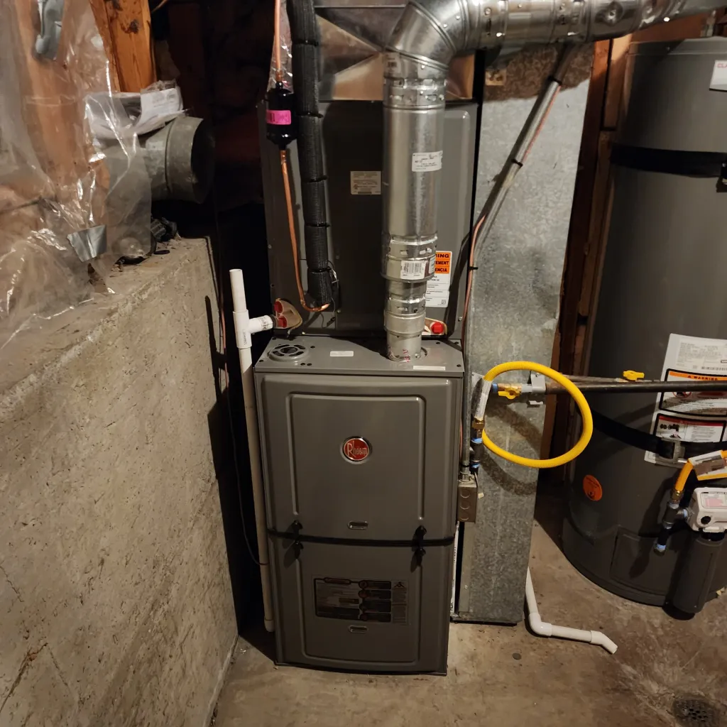 High-efficiency gas furnace installed in a West Jordan, Utah basement, connected to ductwork and gas lines, ready for seasonal heating use.