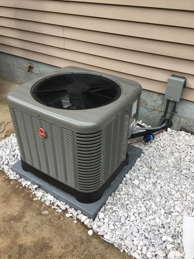 Homeowner checking air conditioner outdoor unit during summer troubleshooting in West Jordan, Utah.