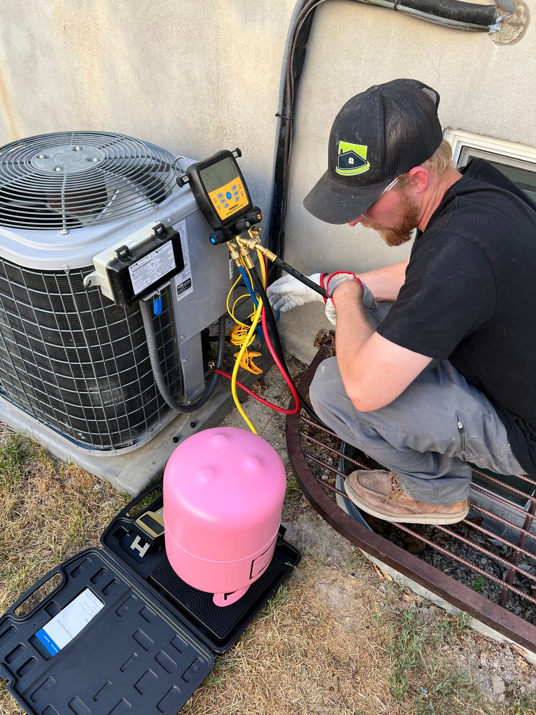 HVAC technician performing routine maintenance on a residential furnace system, ensuring optimal performance and energy efficiency for the home.