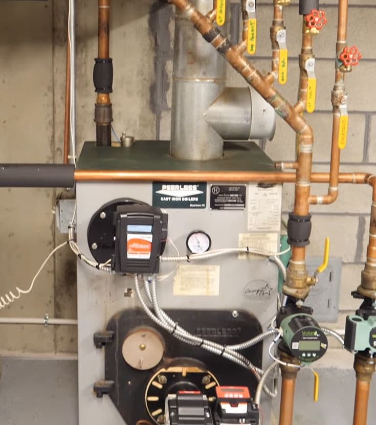 Peerless cast iron boiler with copper piping and gauges installed in a residential Utah home – HVAC furnace system maintenance and repair