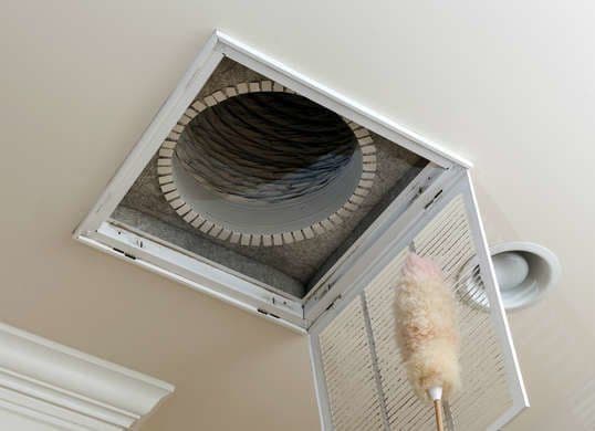 Cleaning an HVAC return vent to improve airflow and winter comfort.