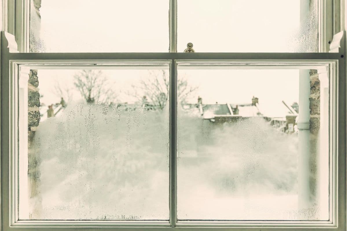 Condensation on interior windows during winter caused by indoor humidity and poor airflow in a home.