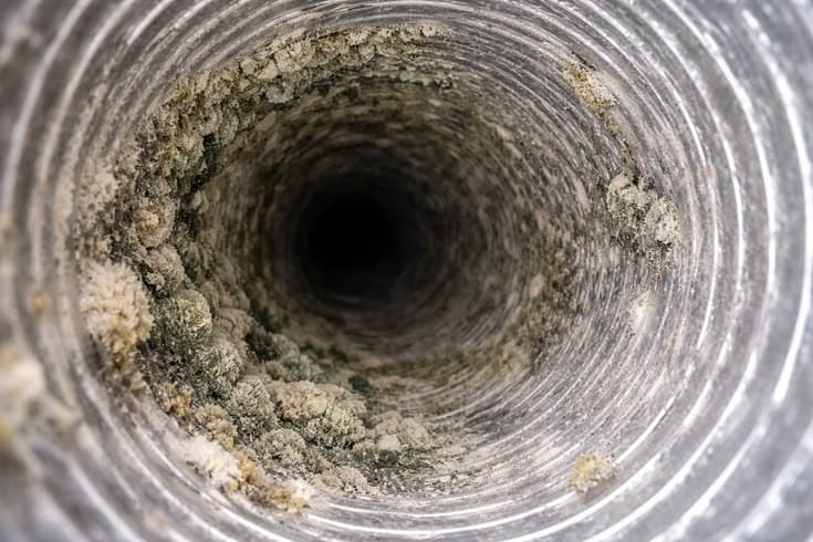 Dirty HVAC duct with dust buildup reducing airflow and indoor air quality.